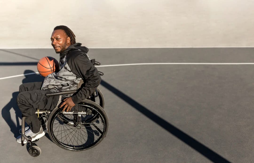 Person in wheelchair playing basketball - living independently with support